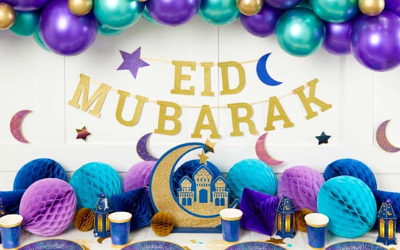 Eid and Ramadan Decoration Ideas Gold 'Eid Mubarak' banner with blue and purple balloons and lantern