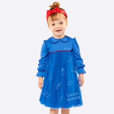 Toddler dressed as Matilda in blue dress and red headband