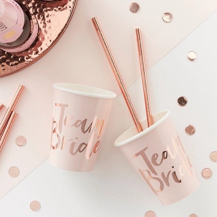 Rose gold hen party cups that say Team Bride