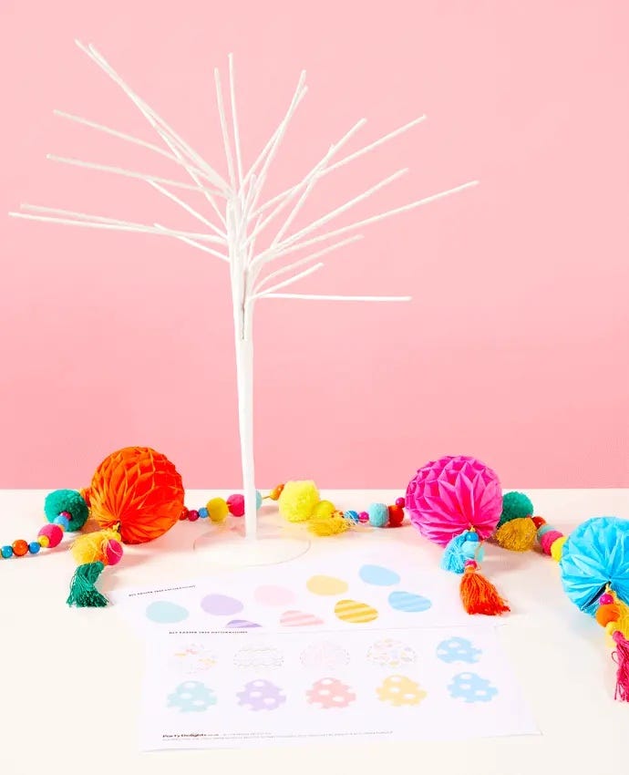 A white Easter tree surrounded by colourful honeycomb decorations