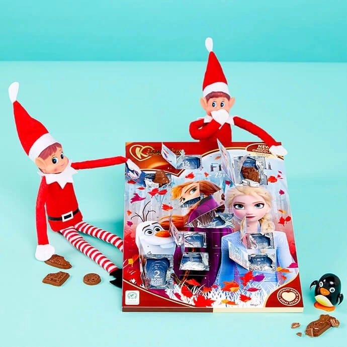 Elf on the Shelf opening an advent calendar