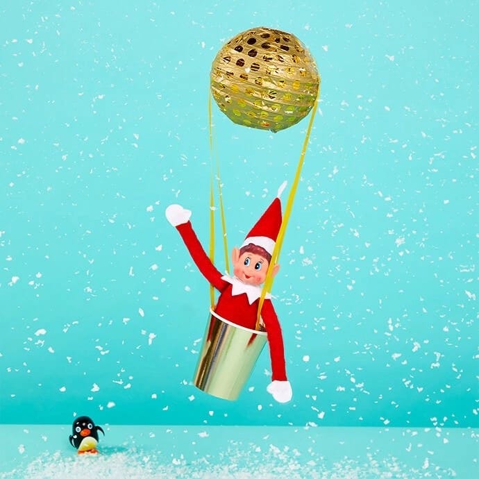 Elf on the Shelf in a hot air balloon made with a ball and a paper cup