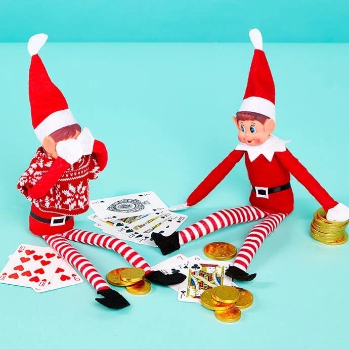 Elf on the Shelf playing poker with another elf