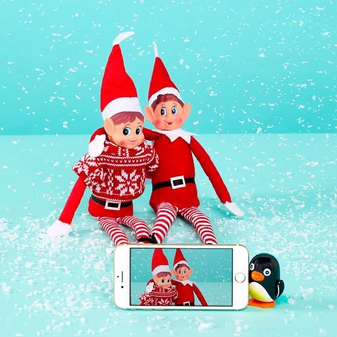 Elf on the Shelf taking a selfie with another elf