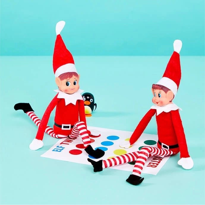 Elf on the Shelf playing twister with another elf
